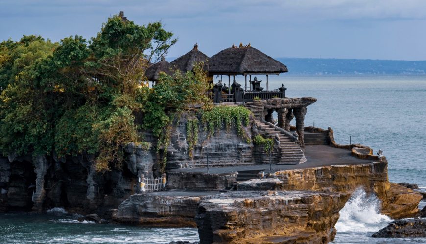 Located on a rocky outcrop in the Indian Ocean, Tanah Lot Temple is one of Bali's most iconic landmarks. Known for its dramatic setting and spiritual significance, this sea temple is a must-visit destination for travelers. Built in the 16th century, Tanah Lot is dedicated to the Balinese sea gods and is an important cultural site.