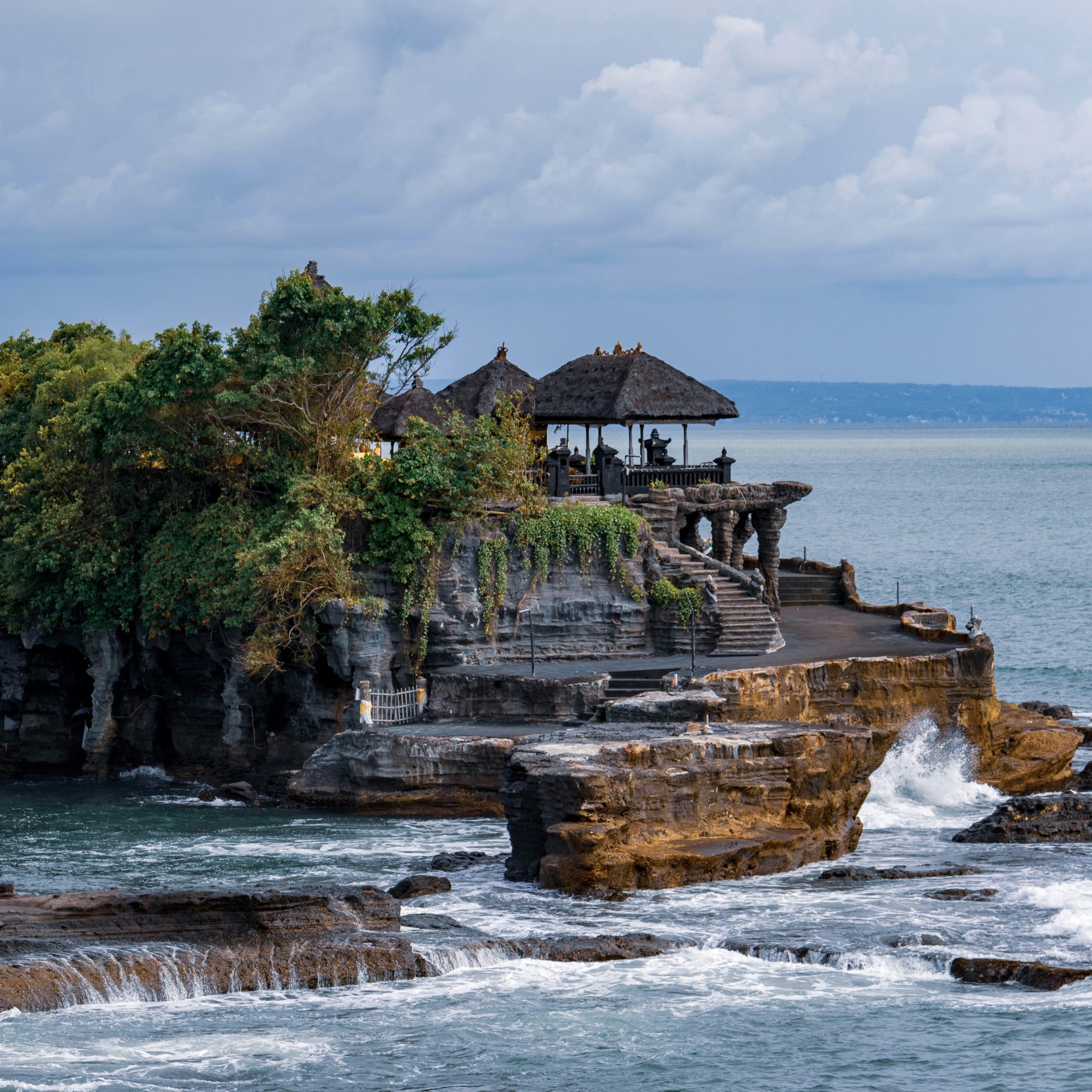 Located on a rocky outcrop in the Indian Ocean, Tanah Lot Temple is one of Bali's most iconic landmarks. Known for its dramatic setting and spiritual significance, this sea temple is a must-visit destination for travelers. Built in the 16th century, Tanah Lot is dedicated to the Balinese sea gods and is an important cultural site.